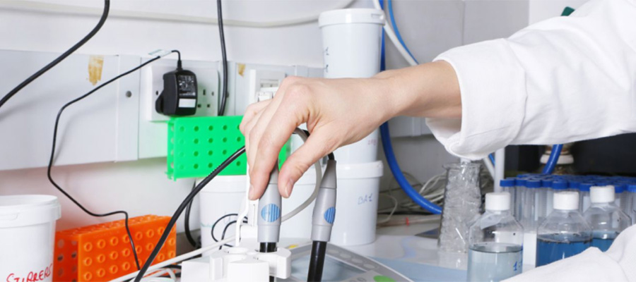 Image of lab worker with pH Meter for article on pH measurement.