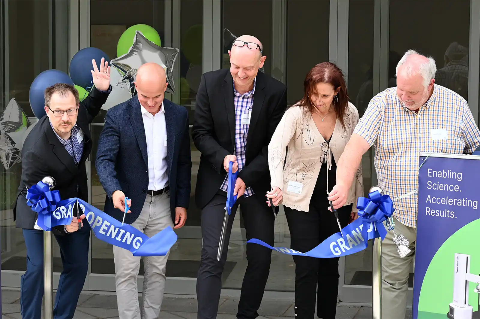 CEO Werner Maas and other team members cut the ribbon during the grand opening ceremony for the new Hudson headquarters.